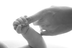 Baby holding finger